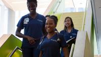 Columbia Nursing students standing on a staircase.